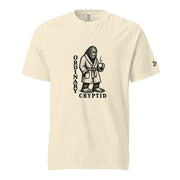 Black ink illustration of Bigfoot wearing a tied bathrobe and holding a steaming mug above the words “Ordinary Cryptid,” shown on a unisex t-shirt.