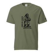Black ink illustration of Bigfoot wearing a tied bathrobe and holding a steaming mug above the words “Ordinary Cryptid,” shown on a unisex t-shirt.