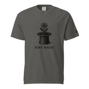 Black vintage-style illustration of a blooming flower growing from a magician's top hat with the words "Dirt Magic" beneath it, rendered in bold botanical line art inspired by classic storybook illustrations on a t-shirt.
