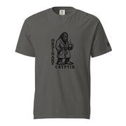 Black ink illustration of Bigfoot wearing a tied bathrobe and holding a steaming mug above the words “Ordinary Cryptid,” shown on a unisex t-shirt.