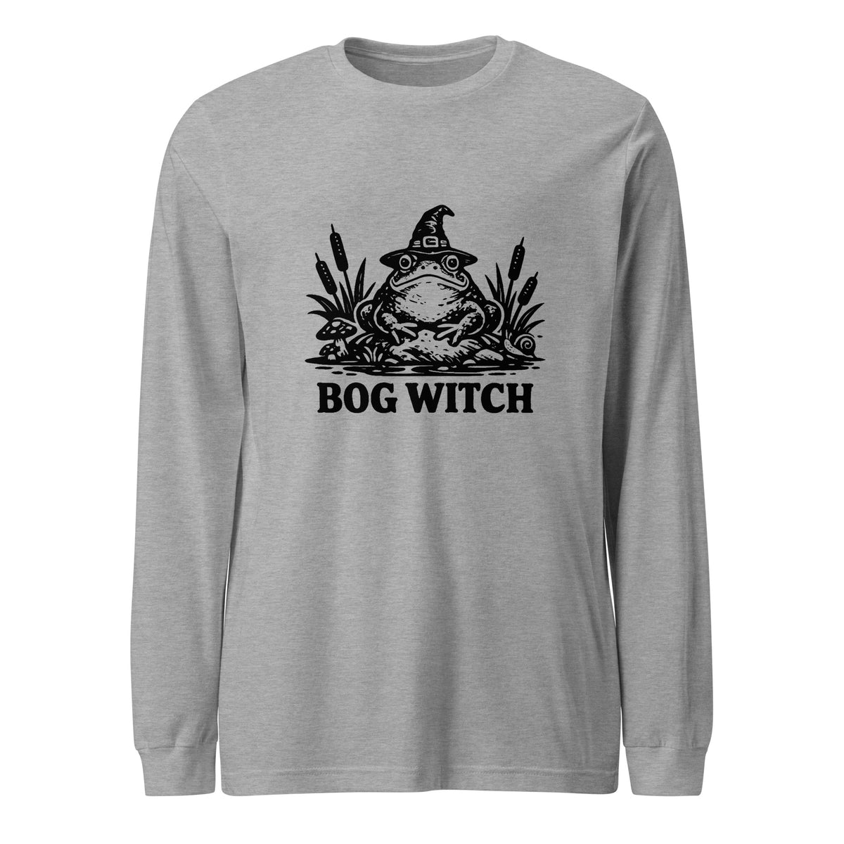 Black ink folk art illustration of a wide-eyed frog beneath an oversized pointed witch hat surrounded by cattails and marsh plants, with the words “BOG WITCH,” on a long sleeve tee.