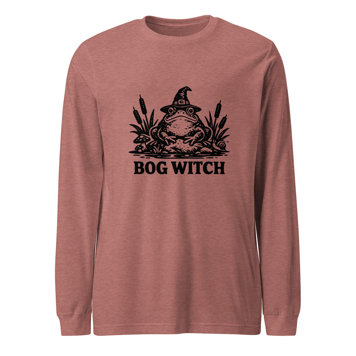 Black ink folk art illustration of a wide-eyed frog beneath an oversized pointed witch hat surrounded by cattails and marsh plants, with the words “BOG WITCH,” on a long sleeve tee.