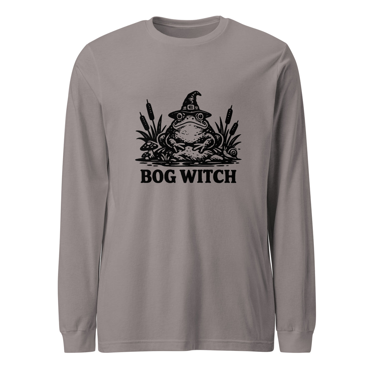 Black ink folk art illustration of a wide-eyed frog beneath an oversized pointed witch hat surrounded by cattails and marsh plants, with the words “BOG WITCH,” on a long sleeve tee.