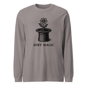 Black vintage-style illustration of a blooming flower growing from a magician's top hat with the words "Dirt Magic" beneath it, rendered in bold botanical line art inspired by classic storybook illustrations on a long-sleeve tee.