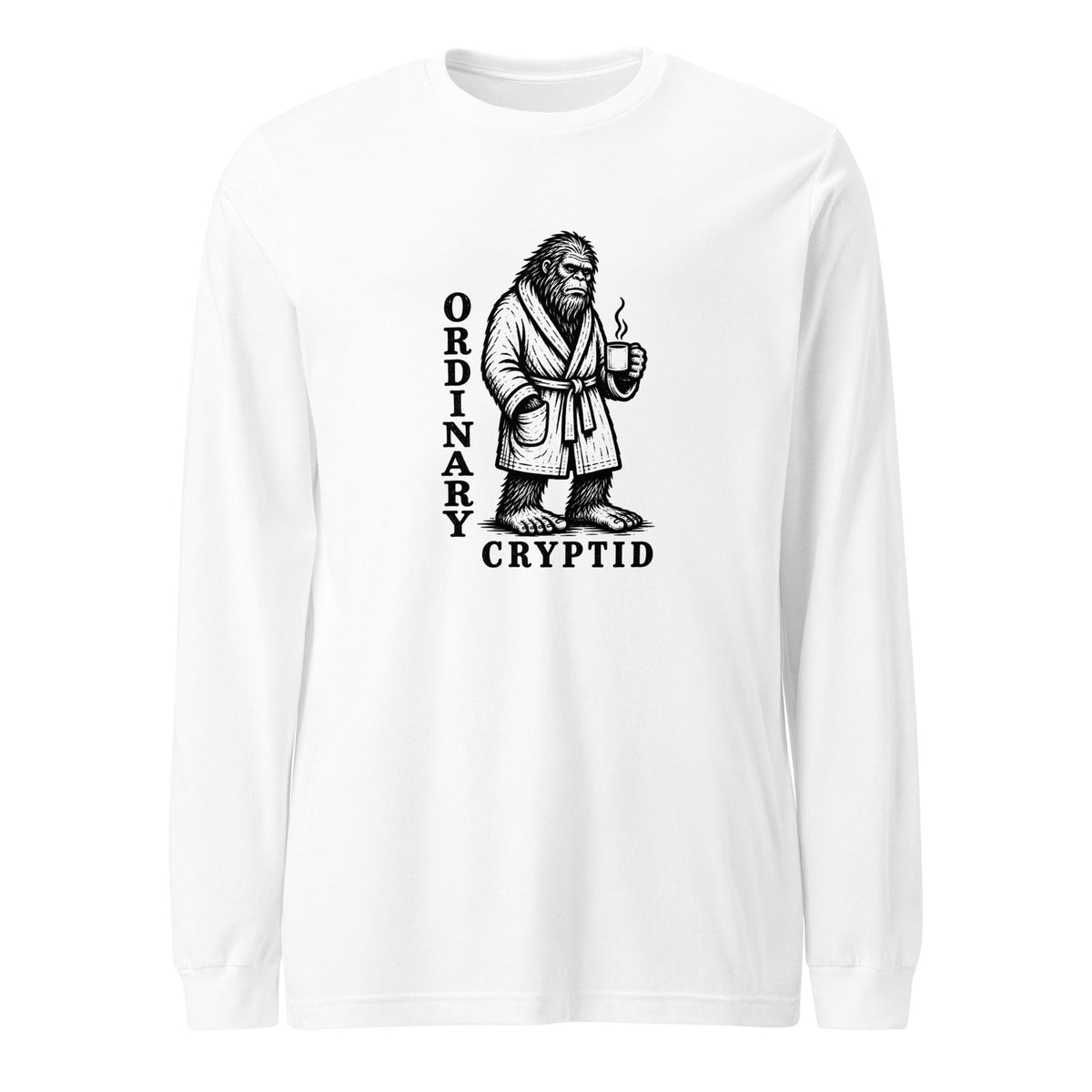 Black ink illustration of Bigfoot wearing a tied bathrobe and holding a steaming mug above the words “Ordinary Cryptid,” shown on a long sleeve tee.