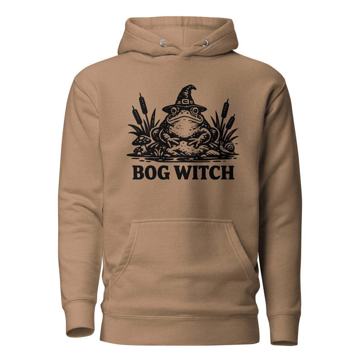 Black ink folk art illustration of a wide-eyed frog beneath an oversized pointed witch hat surrounded by cattails and marsh plants, with the words “BOG WITCH,” on a hoodie.