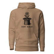 Black vintage-style illustration of a blooming flower growing from a magician's top hat with the words "Dirt Magic" beneath it, rendered in bold botanical line art inspired by classic storybook illustrations on a hoodie.
