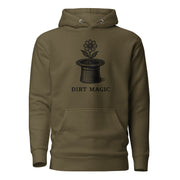 Black vintage-style illustration of a blooming flower growing from a magician's top hat with the words "Dirt Magic" beneath it, rendered in bold botanical line art inspired by classic storybook illustrations on a hoodie.