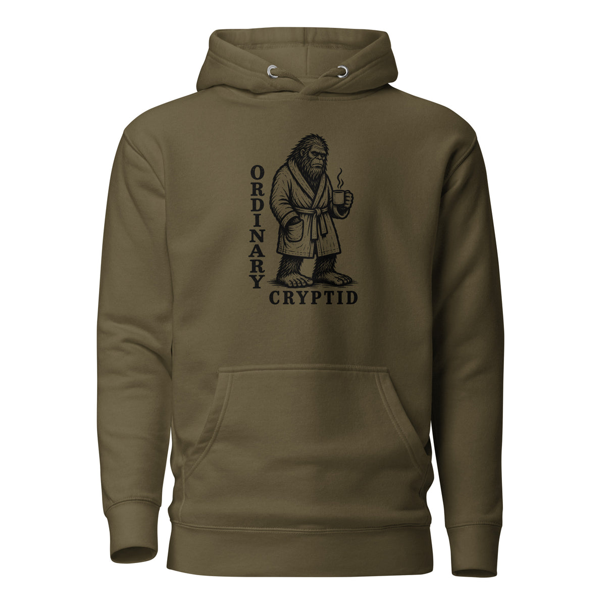 Black ink illustration of Bigfoot wearing a tied bathrobe and holding a steaming mug above the words “Ordinary Cryptid,” shown on a hoodie.