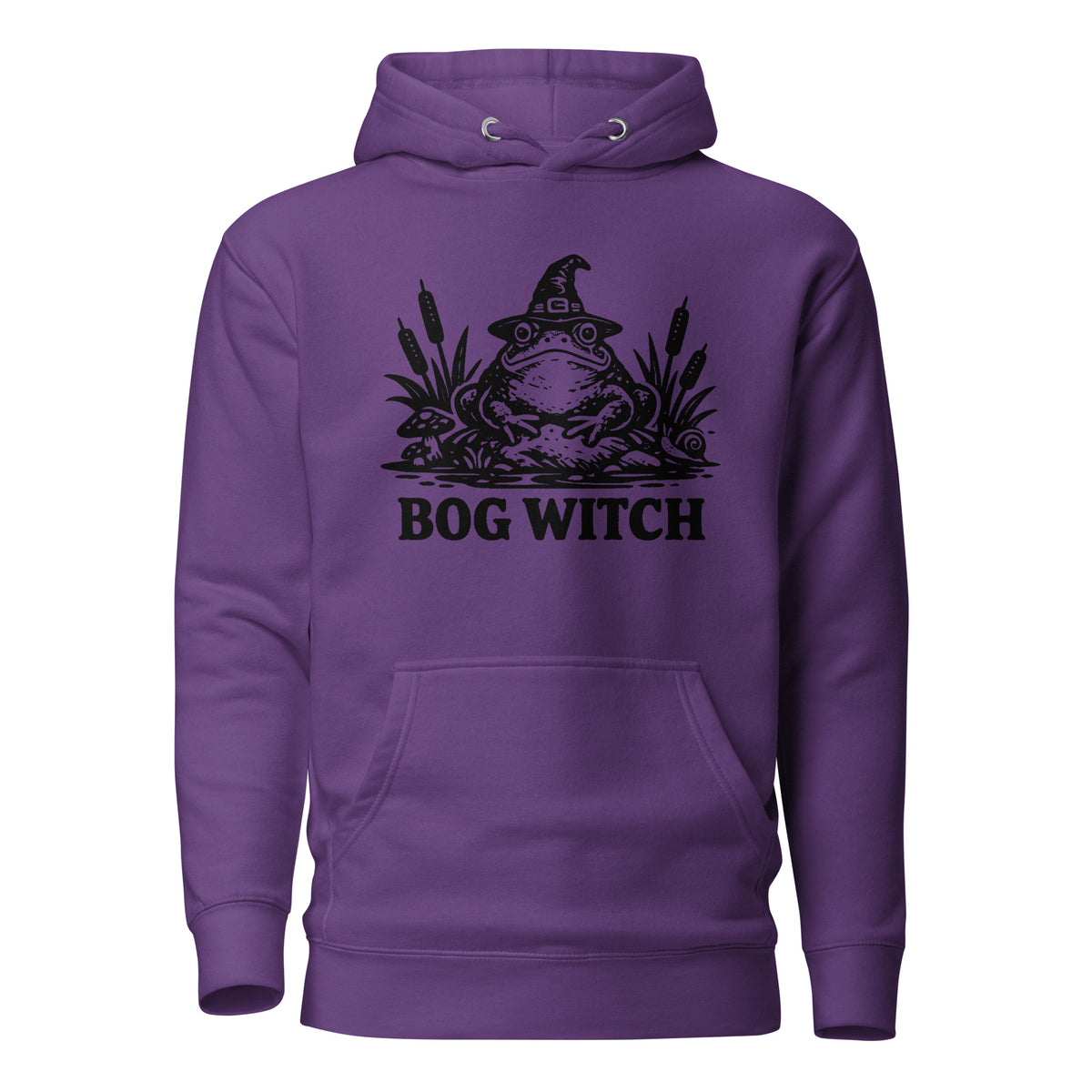 Black ink folk art illustration of a wide-eyed frog beneath an oversized pointed witch hat surrounded by cattails and marsh plants, with the words “BOG WITCH,” on a hoodie.