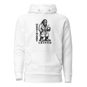 Black ink illustration of Bigfoot wearing a tied bathrobe and holding a steaming mug above the words “Ordinary Cryptid,” shown on a hoodie.