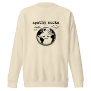 Vintage black-and-white linocut illustration of a sad Earth with a bandage on its forehead beneath rainy clouds and the words "Apathy Sucks" on a sweatshirt.