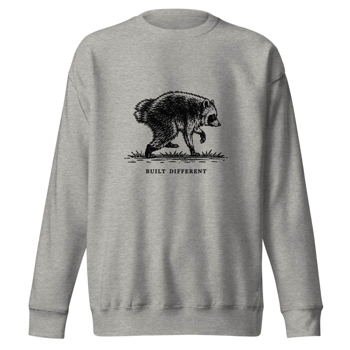 Vintage black-and-white illustration of a raccoon walking above the words "Built Different" on a sweatshirt.