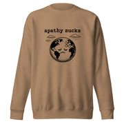 Vintage black-and-white linocut illustration of a sad Earth with a bandage on its forehead beneath rainy clouds and the words "Apathy Sucks" on a sweatshirt.
