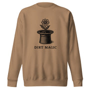 Black vintage-style illustration of a blooming flower growing from a magician's top hat with the words "Dirt Magic" beneath it, rendered in bold botanical line art inspired by classic storybook illustrations on a sweatshirt.