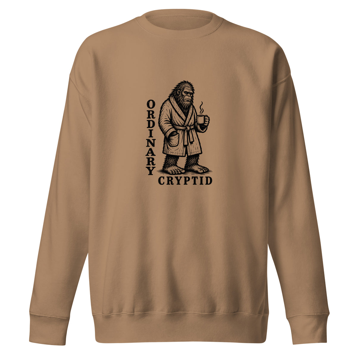 Black ink illustration of Bigfoot wearing a tied bathrobe and holding a steaming mug above the words “Ordinary Cryptid,” shown on a sweatshirt.
