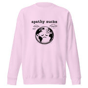 Vintage black-and-white linocut illustration of a sad Earth with a bandage on its forehead beneath rainy clouds and the words "Apathy Sucks" on a sweatshirt.