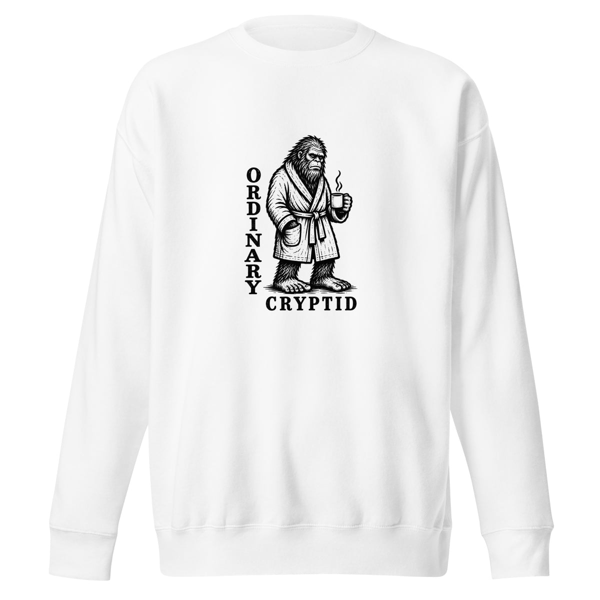 Black ink illustration of Bigfoot wearing a tied bathrobe and holding a steaming mug above the words “Ordinary Cryptid,” shown on a sweatshirt.